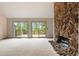 Living room featuring a stone fireplace and sliding doors to a large deck at 1129 Genesee Vista Rd, Golden, CO 80401