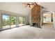 Living room with stone fireplace and sliding doors to a large deck at 1129 Genesee Vista Rd, Golden, CO 80401