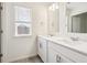 Bathroom with dual sinks, lots of counter space, and a window at 27684 E Byers Ave, Aurora, CO 80018