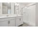 Bright bathroom featuring double sinks, a shower and a large vanity at 27684 E Byers Ave, Aurora, CO 80018
