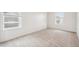 Bedroom with wall-to-wall carpet, and two windows with blinds at 27684 E Byers Ave, Aurora, CO 80018