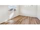 Bright, airy bedroom with hardwood floors and a large window offering neighborhood views at 27684 E Byers Ave, Aurora, CO 80018