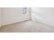 Neutral bedroom featuring carpet, base trim, and a window at 27684 E Byers Ave, Aurora, CO 80018