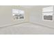 Bright carpeted bedroom featuring two windows at 27684 E Byers Ave, Aurora, CO 80018