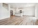 Bright, open-concept kitchen featuring white cabinets, stainless steel appliances, and a large island at 27684 E Byers Ave, Aurora, CO 80018