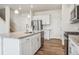 Modern kitchen featuring white cabinets, stainless steel appliances, and a granite island at 27684 E Byers Ave, Aurora, CO 80018