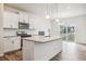 Modern kitchen featuring white cabinets, stainless steel appliances, and a granite island at 27684 E Byers Ave, Aurora, CO 80018