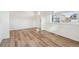 Bright, airy living room with hardwood floors and a large window offering neighborhood views at 27684 E Byers Ave, Aurora, CO 80018