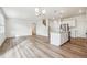 Bright, open-concept living space with hardwood floors, a kitchen island, and modern finishes at 27684 E Byers Ave, Aurora, CO 80018