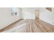 Bright, open-concept living space with hardwood floors, a kitchen island, and modern finishes at 27684 E Byers Ave, Aurora, CO 80018