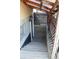 Inviting covered basement entrance with wooden stairs and decorative lattice siding for added charm and privacy at 8095 E Lehigh Ave, Denver, CO 80237