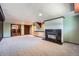 Finished basement featuring a fireplace, carpet, and walkout access at 8095 E Lehigh Ave, Denver, CO 80237