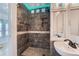 This bathroom features a modern tiled shower with a built-in niche and glass block accents at 8095 E Lehigh Ave, Denver, CO 80237