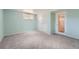 Bedroom featuring a window, closet, light-colored walls, and a door leading to another room at 8095 E Lehigh Ave, Denver, CO 80237