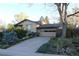 This attractive single-Gathering home features mature landscaping and a long driveway leading to an attached two-car garage at 8095 E Lehigh Ave, Denver, CO 80237