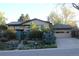 Charming two-story home with lush landscaping and a private front entrance, complemented by an attached two-car garage at 8095 E Lehigh Ave, Denver, CO 80237