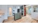 Open kitchen with stainless steel appliances, an island, and ample countertop space at 8095 E Lehigh Ave, Denver, CO 80237