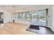 Bright sunroom featuring a ceiling fan, hardwood floors and multiple windows overlooking the yard at 8095 E Lehigh Ave, Denver, CO 80237