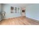 Living room with wood floors, modern lighting, and large openings to create a bright space at 8095 E Lehigh Ave, Denver, CO 80237