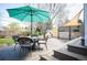 Relax on this outdoor deck with seating and shade, perfect for enjoying the backyard at 2084 Bell Ct, Lakewood, CO 80215