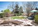 Landscaped backyard with garden plots and a charming shed, offering a peaceful retreat at 2084 Bell Ct, Lakewood, CO 80215