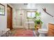 Bathroom with a glass shower, decorative tiles, and a large window at 2084 Bell Ct, Lakewood, CO 80215