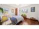 Bedroom with hardwood floors, a patterned blanket, and bright natural light at 2084 Bell Ct, Lakewood, CO 80215