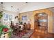 Charming dining room with hardwood floors, brick accent wall, and an open view to the kitchen at 2084 Bell Ct, Lakewood, CO 80215