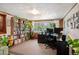 Spacious office featuring a large bookshelf, natural light, and wood trim at 2084 Bell Ct, Lakewood, CO 80215