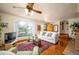 Inviting living room with hardwood floors, a large window, and a decorative ceiling fan at 2084 Bell Ct, Lakewood, CO 80215