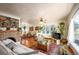 Inviting living room with hardwood floors, brick fireplace, and a large window at 2084 Bell Ct, Lakewood, CO 80215