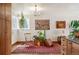 Bright sunroom area with large window, plants, and a small table with a rocking chair at 2084 Bell Ct, Lakewood, CO 80215