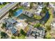 Aerial view of a community showcasing a pool, tennis court, pond, and well-maintained grounds at 2960 S Parker Ct, Aurora, CO 80014