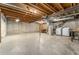 Unfinished basement featuring exposed beams, a utility sink, and washer and dryer hookups at 2960 S Parker Ct, Aurora, CO 80014