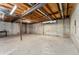 Unfinished basement featuring exposed wooden ceiling and concrete walls at 2960 S Parker Ct, Aurora, CO 80014