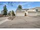 A charming townhouse featuring two single-car garages, a landscaped front, and a well-maintained exterior at 2960 S Parker Ct, Aurora, CO 80014