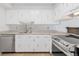 Bright kitchen with white cabinets and stainless steel appliances, with neutral countertops at 2960 S Parker Ct, Aurora, CO 80014