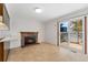 Bright living room featuring a cozy fireplace and sliding glass doors to the outdoors at 2960 S Parker Ct, Aurora, CO 80014