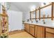 Spacious bathroom featuring a double vanity, white countertops and a bathtub shower with white curtain at 23646 Genesee Village Rd, Golden, CO 80401
