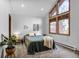 Bright bedroom with large windows, and neutral carpet, creating a serene and inviting space at 23646 Genesee Village Rd, Golden, CO 80401