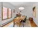 Bright dining room featuring a modern light fixture, a large window, and space for Gathering gatherings at 23646 Genesee Village Rd, Golden, CO 80401
