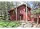 Attractive exterior view of home with a welcoming front entrance and mature trees at 23646 Genesee Village Rd, Golden, CO 80401
