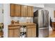 Functional kitchen with stainless steel refrigerator, butcher block countertops, and ample cabinet space for storage at 23646 Genesee Village Rd, Golden, CO 80401