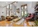 Spacious living room with high ceilings, large windows, and hardwood floors, creating a bright and airy atmosphere at 23646 Genesee Village Rd, Golden, CO 80401