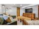 Stylish living room with a comfortable sectional sofa, modern lighting, and entertainment center with a large screen TV at 23646 Genesee Village Rd, Golden, CO 80401