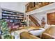 Inviting living room with a soaring ceiling, a cozy fireplace, a built-in bookcase, and stylish decor at 23646 Genesee Village Rd, Golden, CO 80401