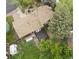 Aerial shot of a home showcasing a backyard with lush landscaping, a deck, and a greenhouse at 9236 W Euclid Ave, Littleton, CO 80123