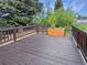 Wood back deck featuring flower planters and surrounding trees at 9236 W Euclid Ave, Littleton, CO 80123