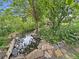 Backyard pond with lush vegetation and rocks for a tranquil scenery at 9236 W Euclid Ave, Littleton, CO 80123