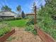 Backyard features a garden, a lawn, shed, and mature trees at 9236 W Euclid Ave, Littleton, CO 80123